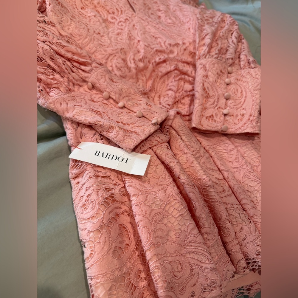 Bardot pink lace mini dress with puffed sleeve, button cuffs.